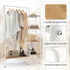 A white metal and wood garment rack with clothes hanging on it and shelves for storage. The image also includes close-up shots highlighting product features. Produktbild-Vorschau