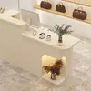 A retail counter with a computer, payment devices, and decorative items. Produktbild-Vorschau