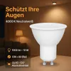 A white LED light bulb is shown in the foreground, with a living room scene in the background. Produktbild-Vorschau