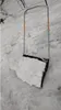 A snow shovel filled with snow, resting on a snowy surface. Produktbild-Vorschau