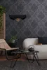 A living room scene with a sofa, chair, coffee table, and wallpaper. Produktbild-Vorschau