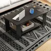A modern coffee table with a shelf, a laptop, a mug, and a small pastry on a patterned rug. Produktbild-Vorschau