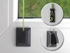 Close-up views of a window installation accessory for blinds, showing its attachment mechanism. Produktbild-Vorschau