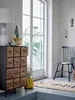 A bright room with a large window, a chest of drawers, a chair, and a rug. Náhľad obrázku produktu