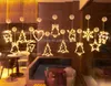 Christmas-themed LED lights hanging in a room with furniture. Produktbild-Vorschau