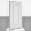 A white 3D wall panel is displayed diagonally on a white pedestal, with a background of white and gray paneled walls. Produktbild-Vorschau