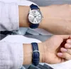 Two images of a man's wrist wearing a silver Casio watch with a blue leather strap. Voir les images du produit