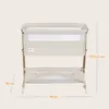A beige and white baby bassinet with dimensions indicated by text overlays. Produktbild-Vorschau