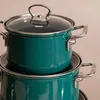 Two teal pots are stacked on top of each other against a light pink background. Produktbild-Vorschau