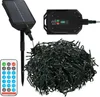 A collection of solar-powered string lights, a remote control, and a solar panel with a control box. Produktbild-Vorschau