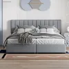 A modern bedroom with a gray upholstered bed as the main focus. Produktbild-Vorschau