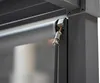 A close-up view of a roller blind mechanism attached to a dark gray metal frame, likely part of a pergola or awning system. Produktbild-Vorschau