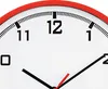 A close-up view of a white analog clock with a red rim and black hour and minute hands. Voir les images du produit