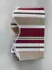 A striped awning fabric is folded and presented against a white background. Produktbild-Vorschau
