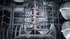 A close-up view inside a dishwasher, showing the racks and spray arms. Anteprima dell’immagine prodotto