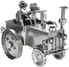 A metal sculpture of a tractor with two figures and a dog. Anteprima dell’immagine prodotto