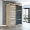 A modern sliding door wardrobe is shown in a room with a concrete wall and wooden floor. Produktbild-Vorschau