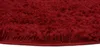 A close-up view of a dark red, plush rug. Anteprima dell’immagine prodotto
