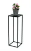 A black metal plant stand with a pot of pink flowers on top, set against a white background. Anteprima dell’immagine prodotto
