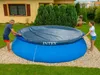 A man and a woman are covering an inflatable pool with a dark cover in a backyard. Produktbild-Vorschau