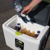 A hand is pouring liquid from a bottle into a cooler box filled with drinks. Produktbild-Vorschau