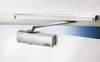 A close-up shot of a door closer mounted on a door and door frame. Produktbild-Vorschau