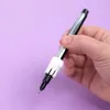 A hand holding a pen with a white attachment. Produktbild-Vorschau