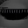 Icicle lights hanging from a snow-covered roof during winter. Produktbild-Vorschau