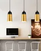 Three pendant lights hang above a counter with a computer and a framed picture. Produktbild-Vorschau