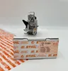 A STIHL carburetor is placed on its original packaging box. Produktbild-Vorschau