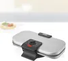 A waffle maker on a countertop with a blurred background. Produktbild-Vorschau
