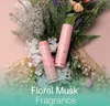 Two pink Kahi Wrinkle Bounce Multi Balm sticks are placed among a bouquet of flowers and greenery. Náhled obrázku produktu