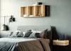 A bedroom scene with a bed, pillows, and wooden crates used as shelves and a nightstand. Produktbild-Vorschau