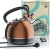A copper-colored electric kettle with a black handle and base, displayed with its packaging in the background. A power cord and a filter are also visible in the foreground. Anteprima dell’immagine prodotto