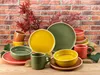 A collection of ceramic dishes and mugs arranged on a wooden surface in front of a brick wall, with autumn leaves as decoration. Náhľad obrázku produktu