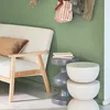 A cozy corner with a sofa, side table, and decorative items. Produktbild-Vorschau