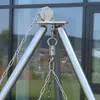 A close-up view of a stainless steel swivel hook and chain assembly, likely for a swing or grill, against a blurred background of a building with windows. Anteprima dell’immagine prodotto