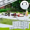 A picnic table set up outdoors with food and drinks. Náhľad obrázku produktu