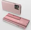 A pink smartphone with a clear view flip case is shown from two angles against a light gray background. Produktbild-Vorschau