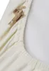 A close-up view of a cream-colored fabric with a teddy bear pattern and elasticized edge. Produktbild-Vorschau