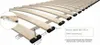 Close-up view of a wooden bed frame slatted base with dimensions and assembly instructions indicated by text. Produktbild-Vorschau