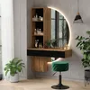 A modern vanity set with a circular LED mirror, shelving, and a green stool in a well-lit room. Voir les images du produit