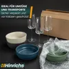 Bowls and glasses are arranged on a black surface with a cardboard box in the background, suggesting packaging for moving or transport. Produktbild-Vorschau