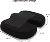 A black ergonomic seat cushion with dimensions indicated by text and lines. Produktbild-Vorschau