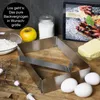 A baking scene with ingredients and a cake frame. Anteprima dell’immagine prodotto