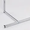 A close-up view of the chrome-plated metal leg of a table. Produktbild-Vorschau