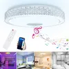 Collage of a ceiling light with music notes, a remote control, a smartphone, and lifestyle shots of the light in different rooms. Voir les images du produit