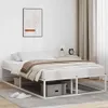 A white metal bed frame with a mattress and bedding in a bedroom setting. Náhľad obrázku produktu