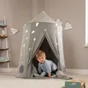 A young child is playing inside a tent decorated with space-themed motifs. Podgląd zdjęcia produktu