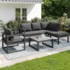 An outdoor patio set with a sectional sofa, armchair, and coffee table on a rug in a backyard setting. Anteprima dell’immagine prodotto